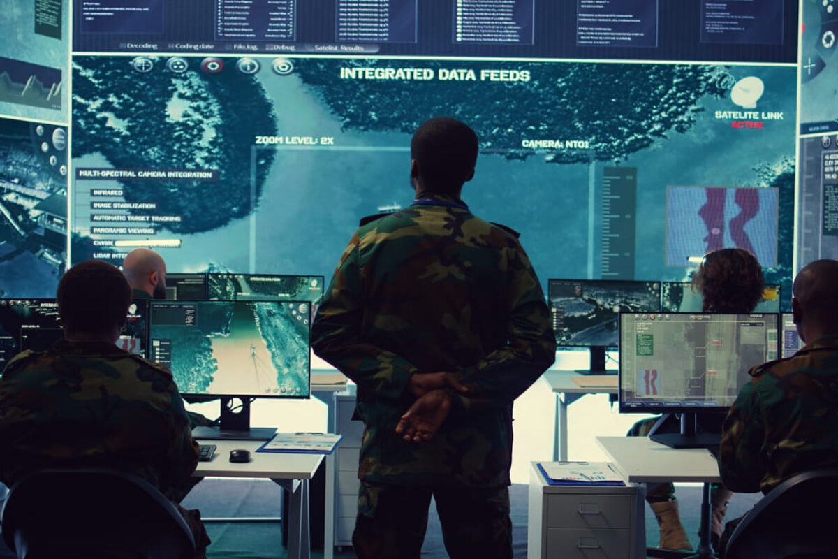 army-officer-examining-satellite-surveillance-footage-big-screen
