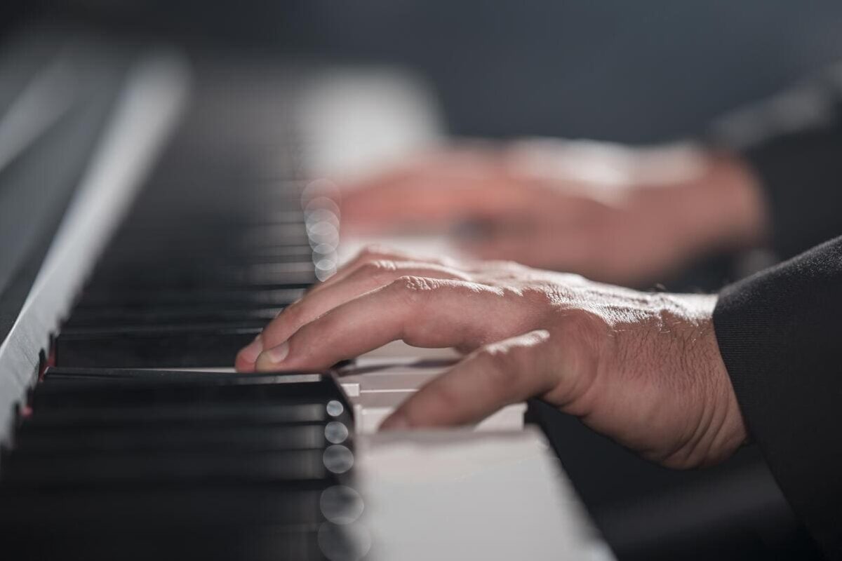 close-up-blurred-hands-playing-digital-piano