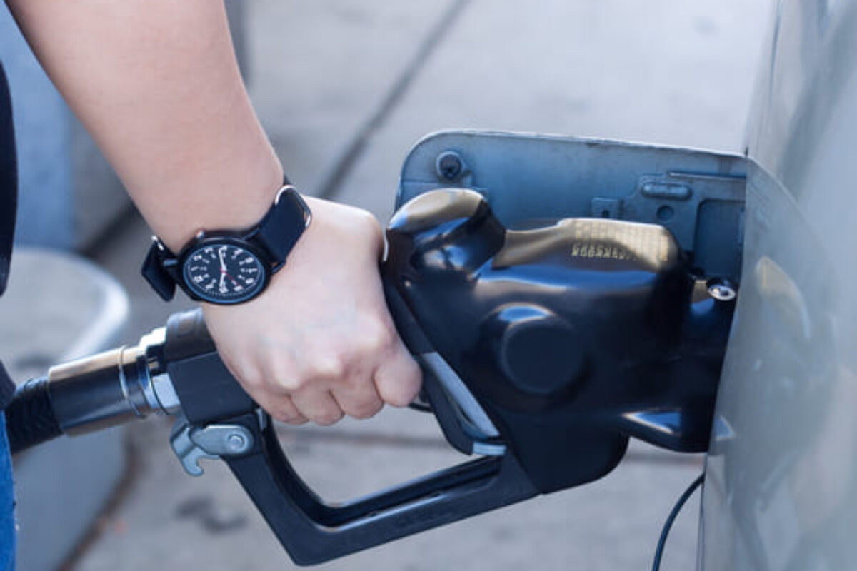 close-up-woman-hand-putting-gas-into-car-gas-station