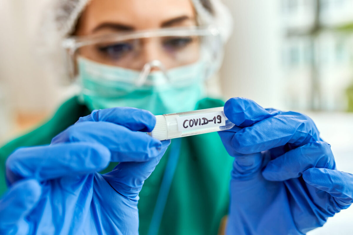 closeup-epidemiologist-with-covid19-sample-test-tube