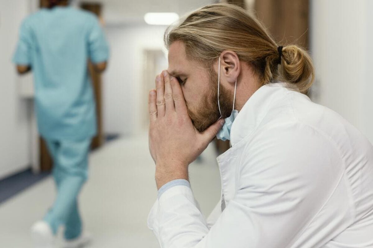 medium-shot-tired-doctor-with-mask